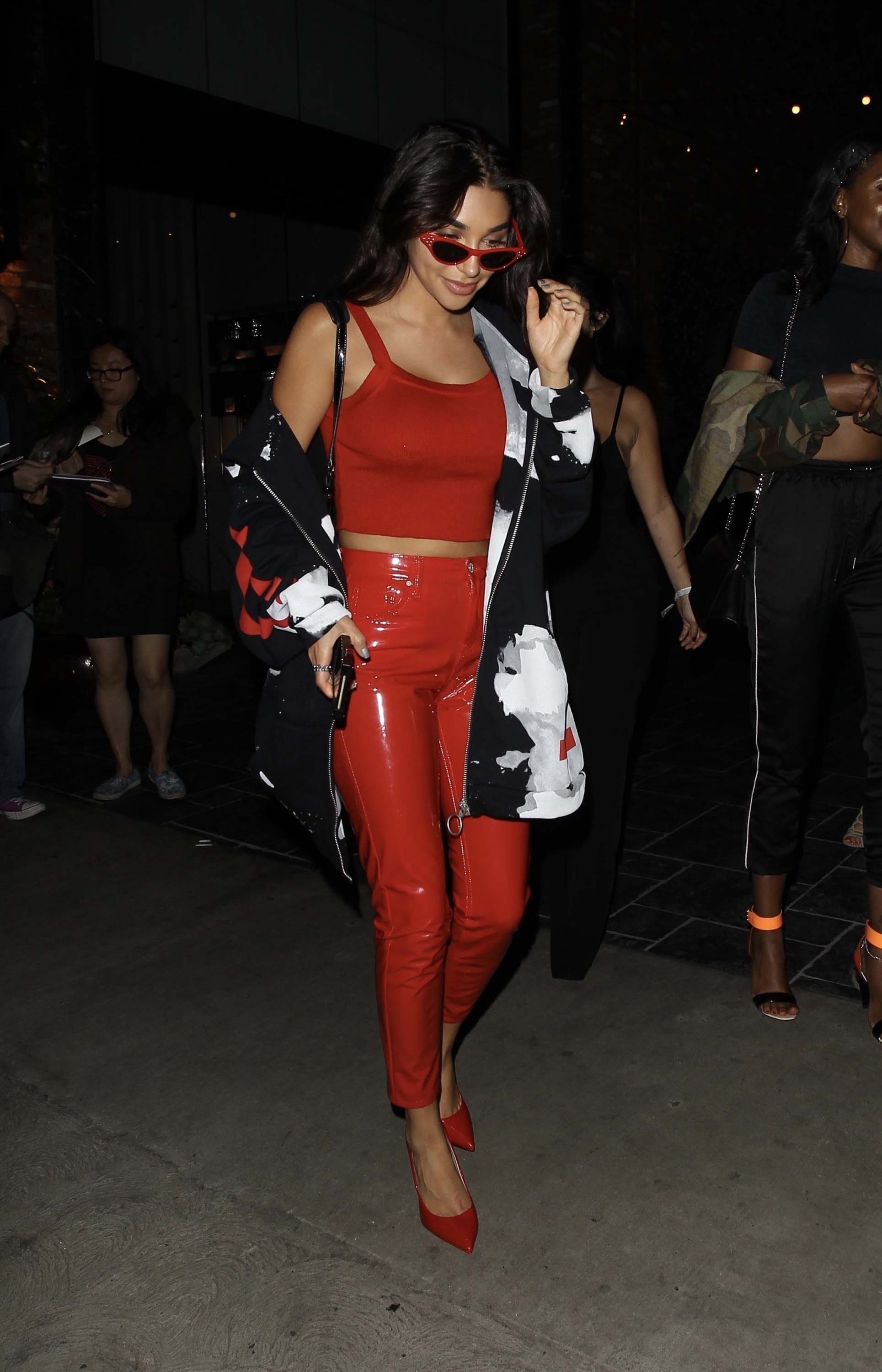 Chantel Jeffries smiles and poses for photos in a red hot form fitting outfit