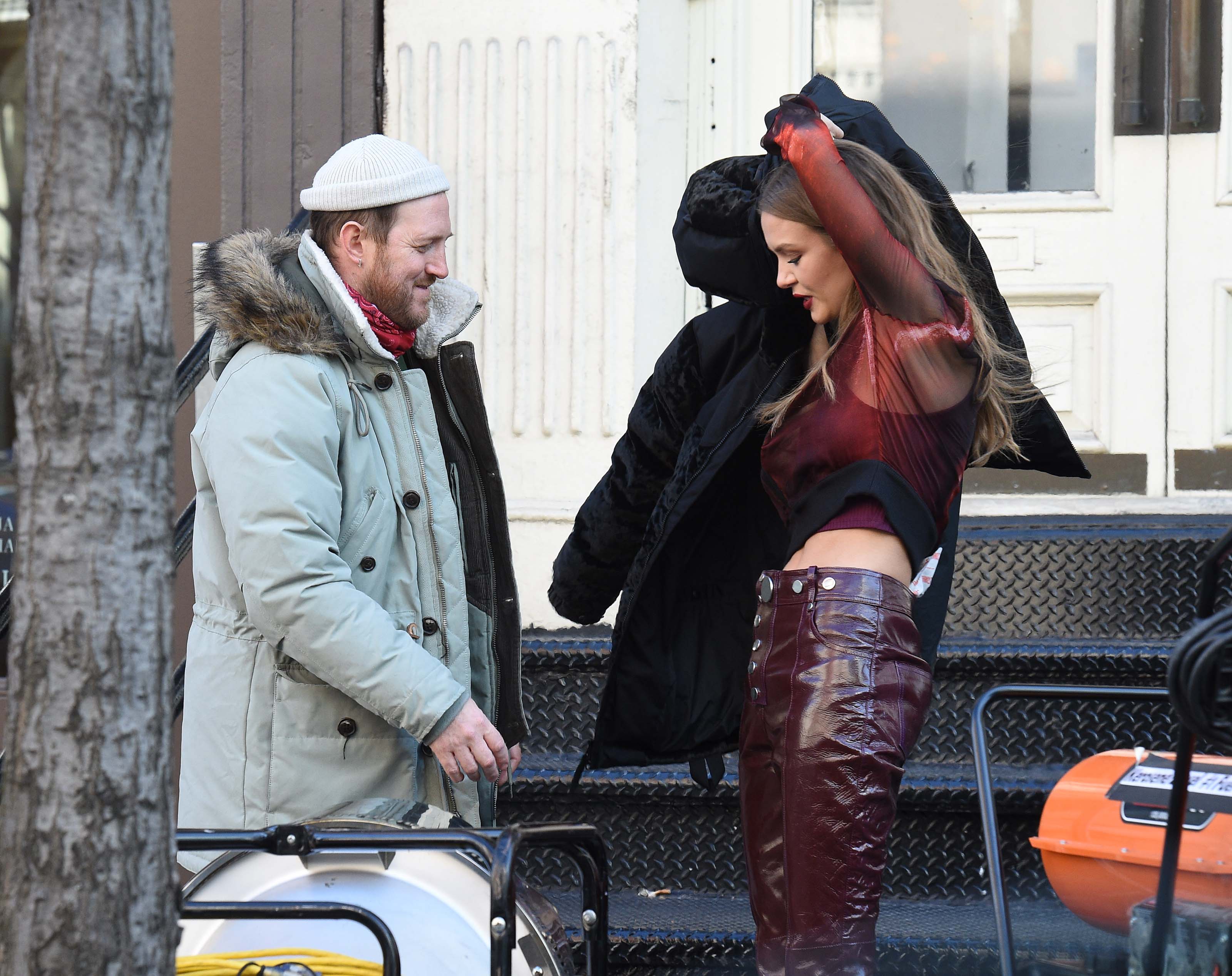 Josephine Skriver takes a break on the set of a photoshoot for Maybelline