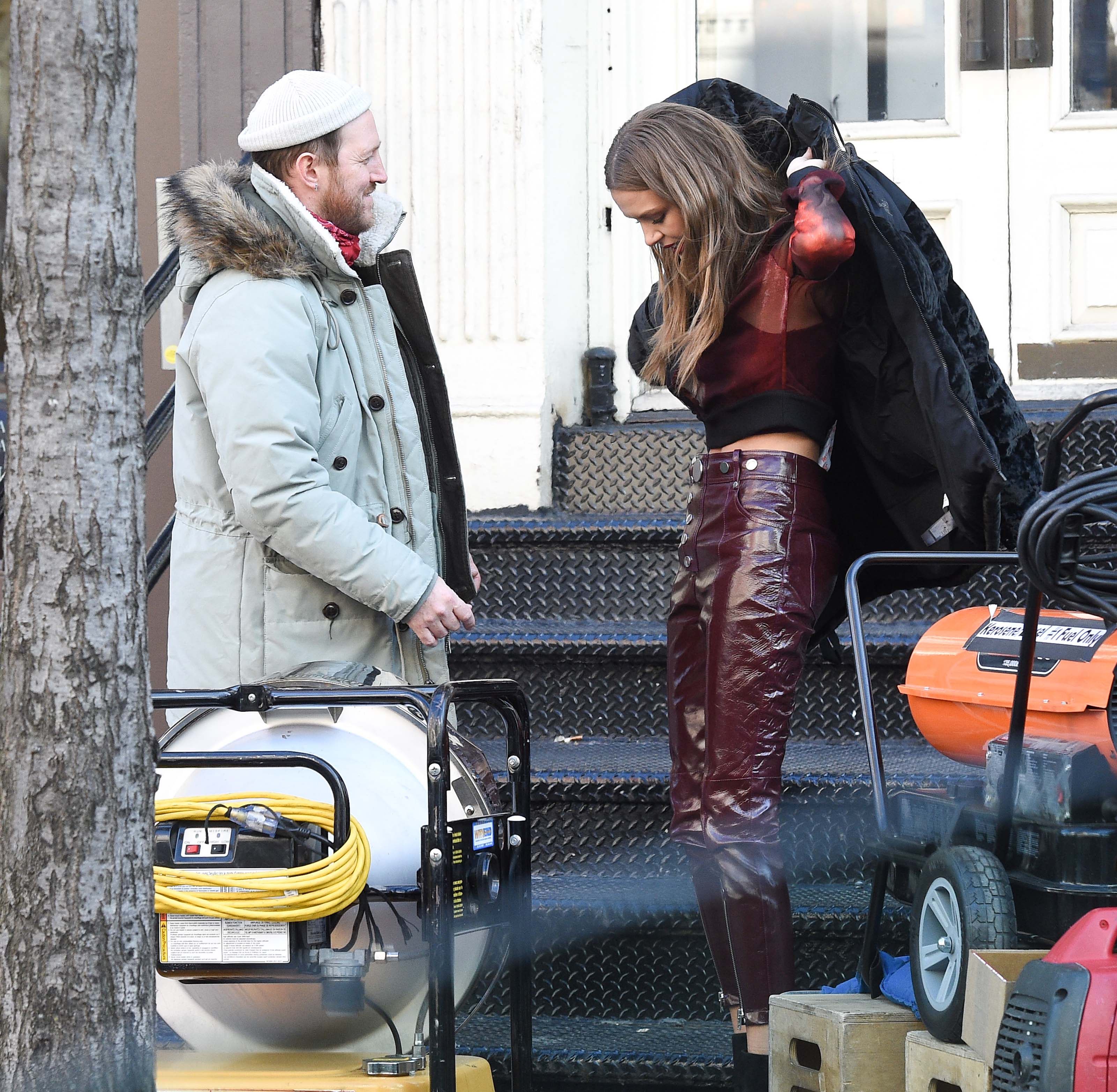 Josephine Skriver takes a break on the set of a photoshoot for Maybelline