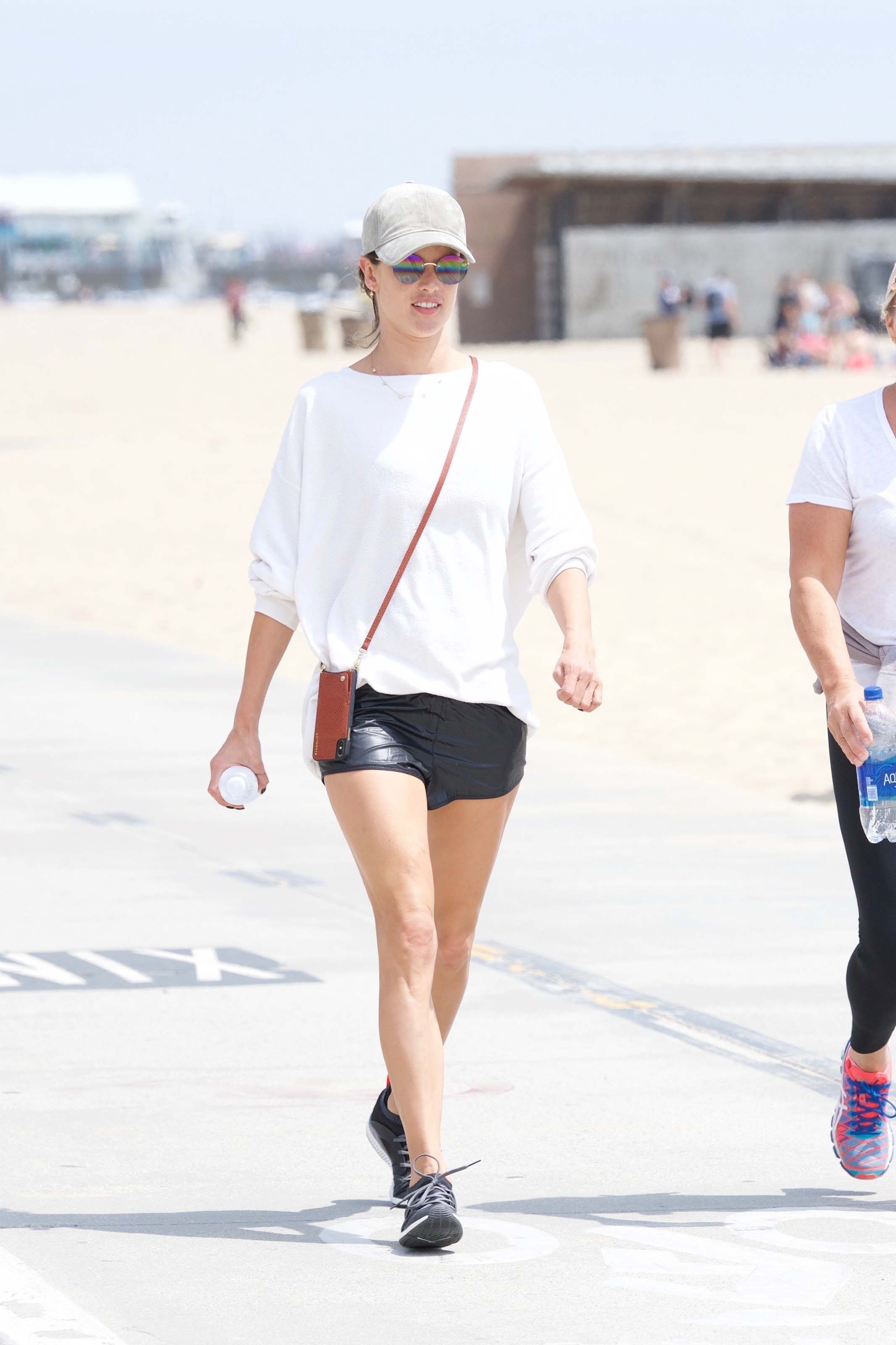 Alessandra Ambrosio walking along the beach