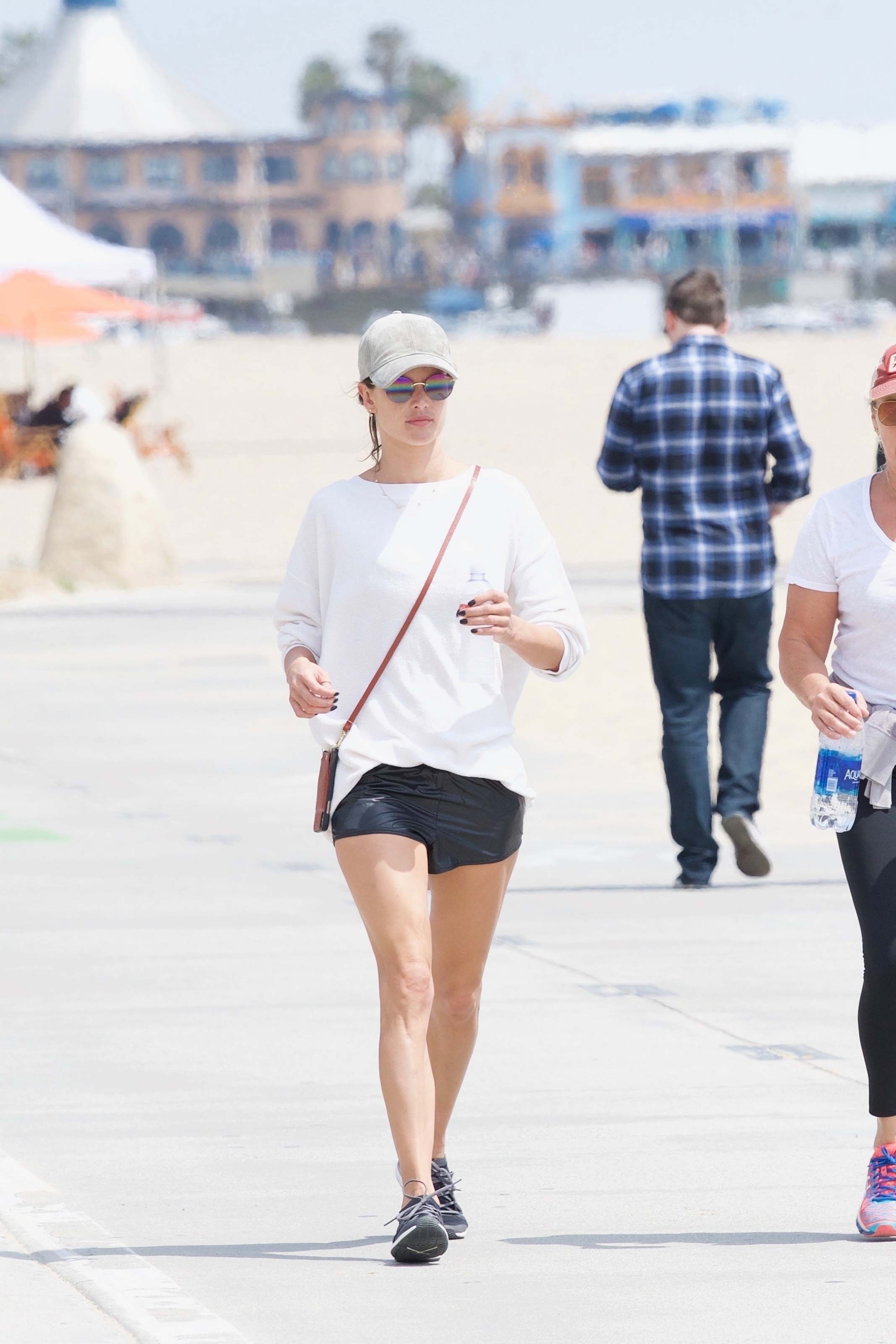 Alessandra Ambrosio walking along the beach