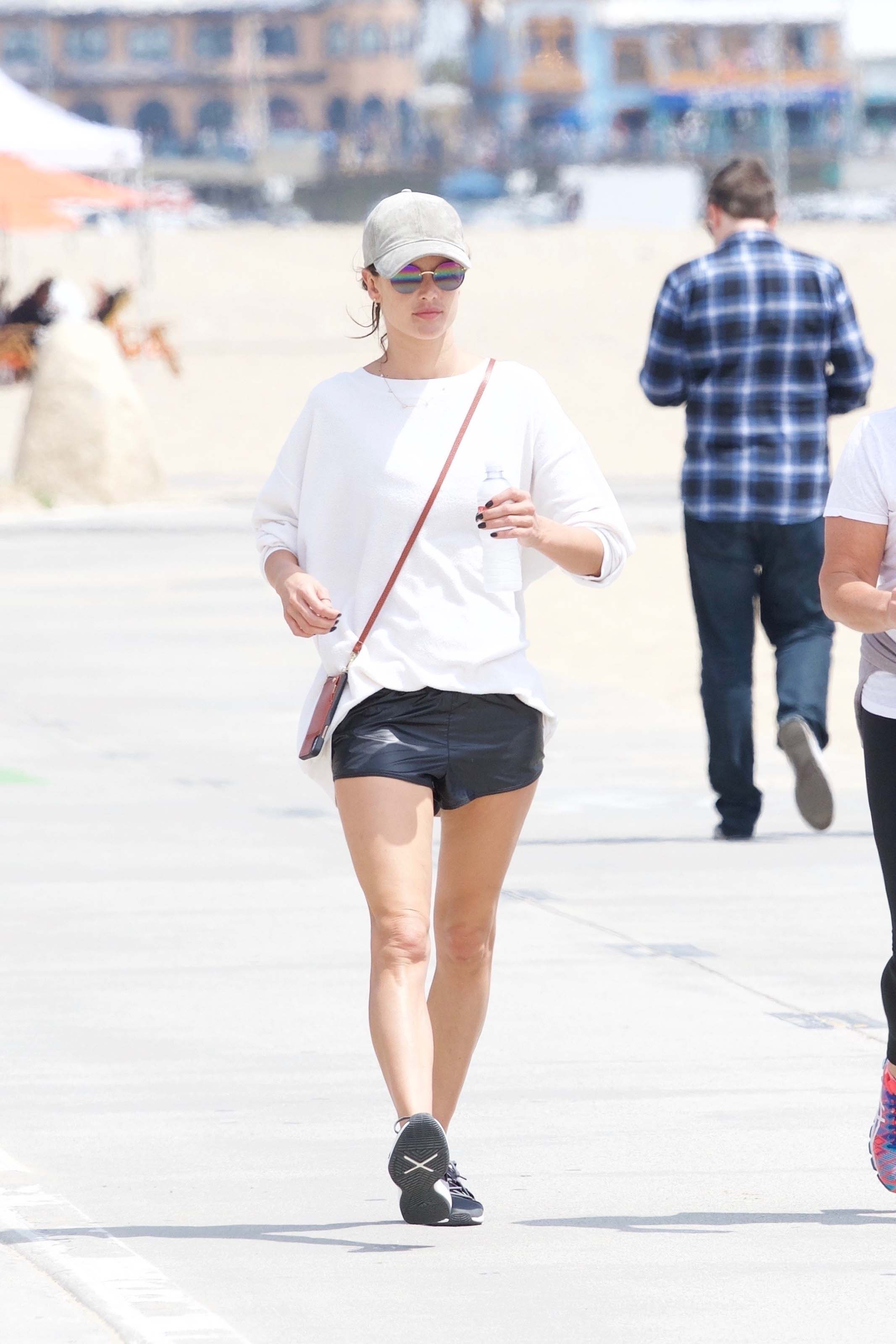 Alessandra Ambrosio walking along the beach