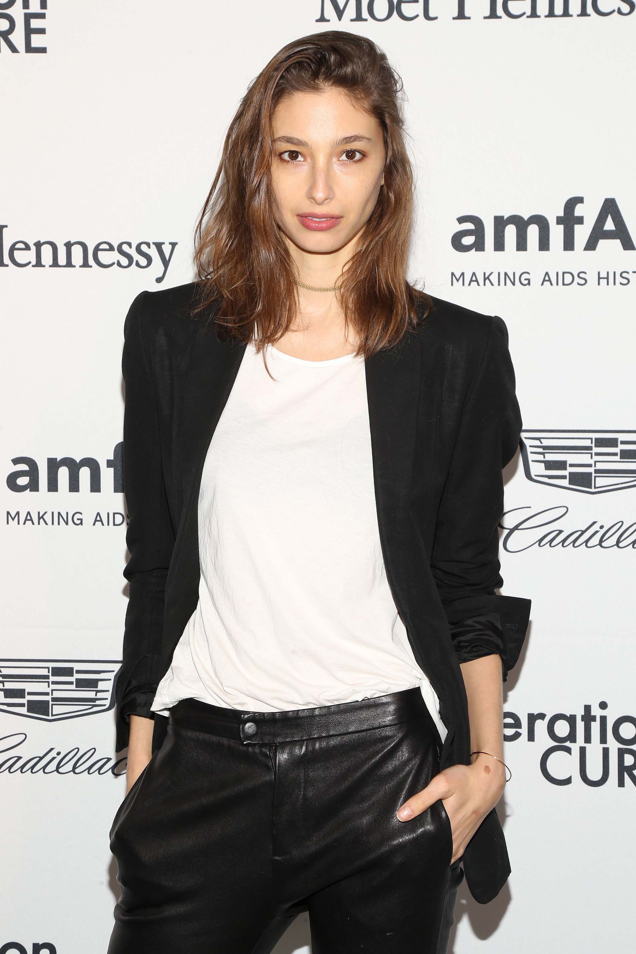 Alexandra Agoston attends amfAR GenerationCure holiday party