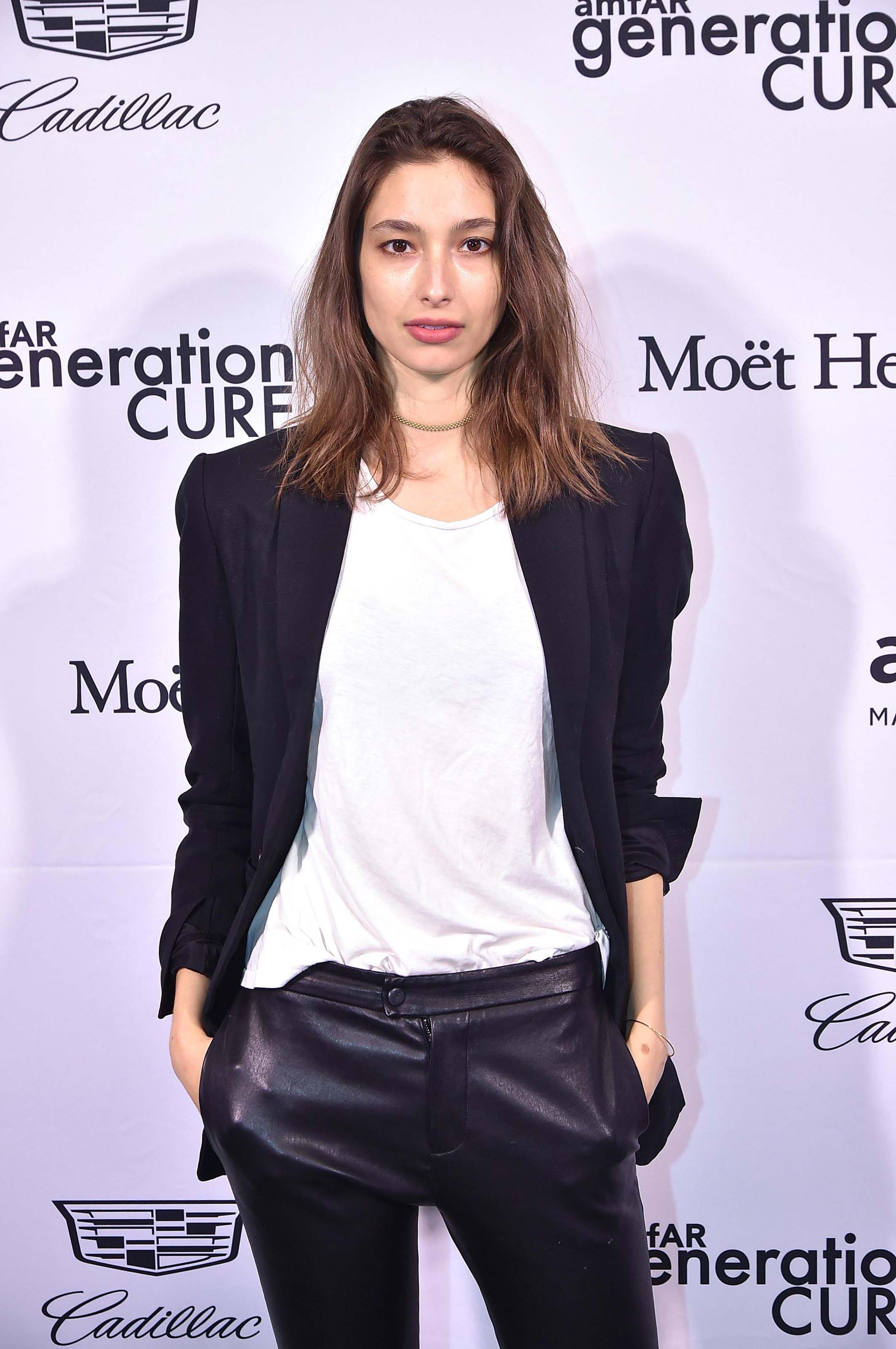 Alexandra Agoston attends amfAR GenerationCure holiday party