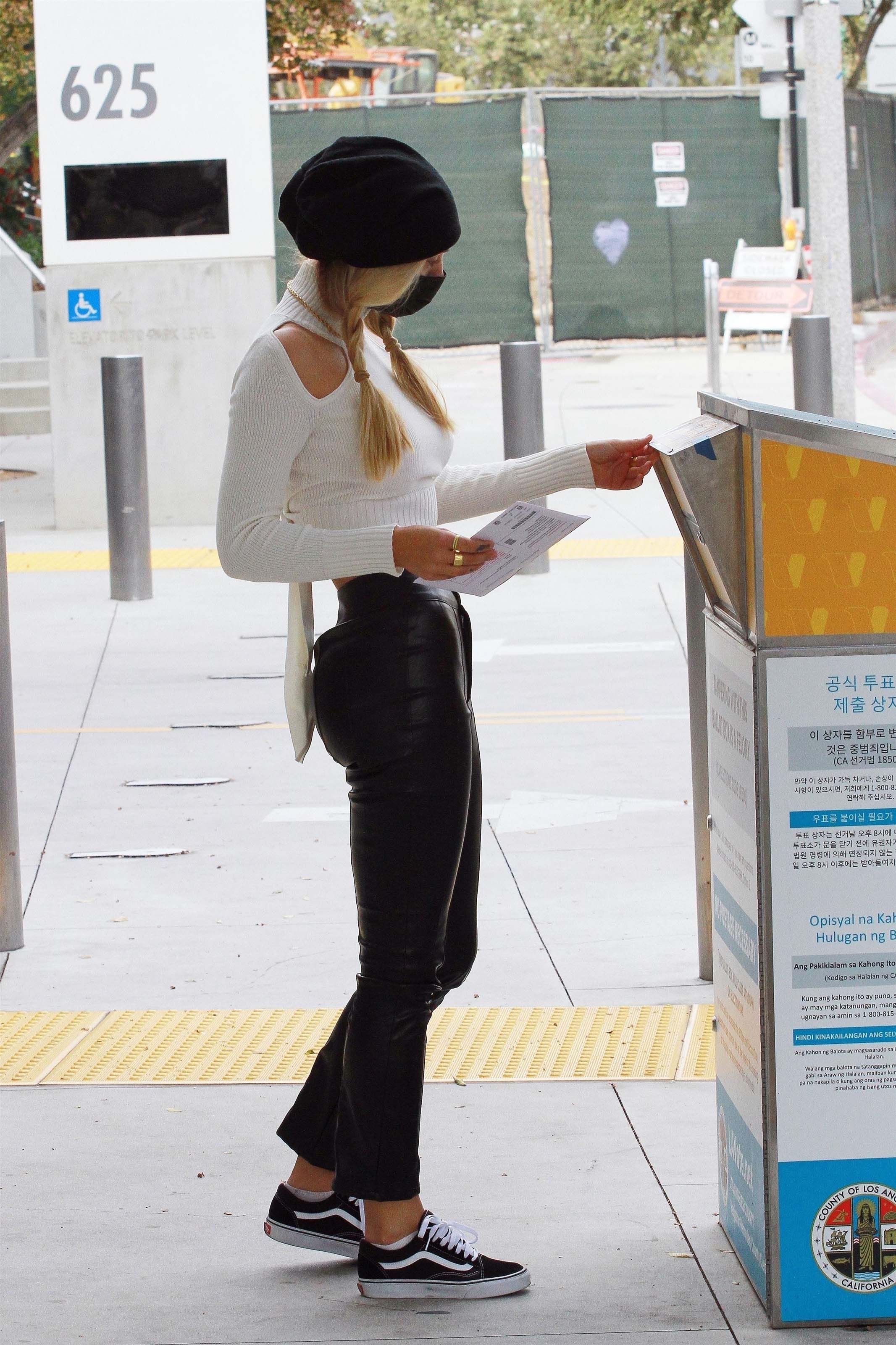 Alexis Ren casting her vote at a ballot box