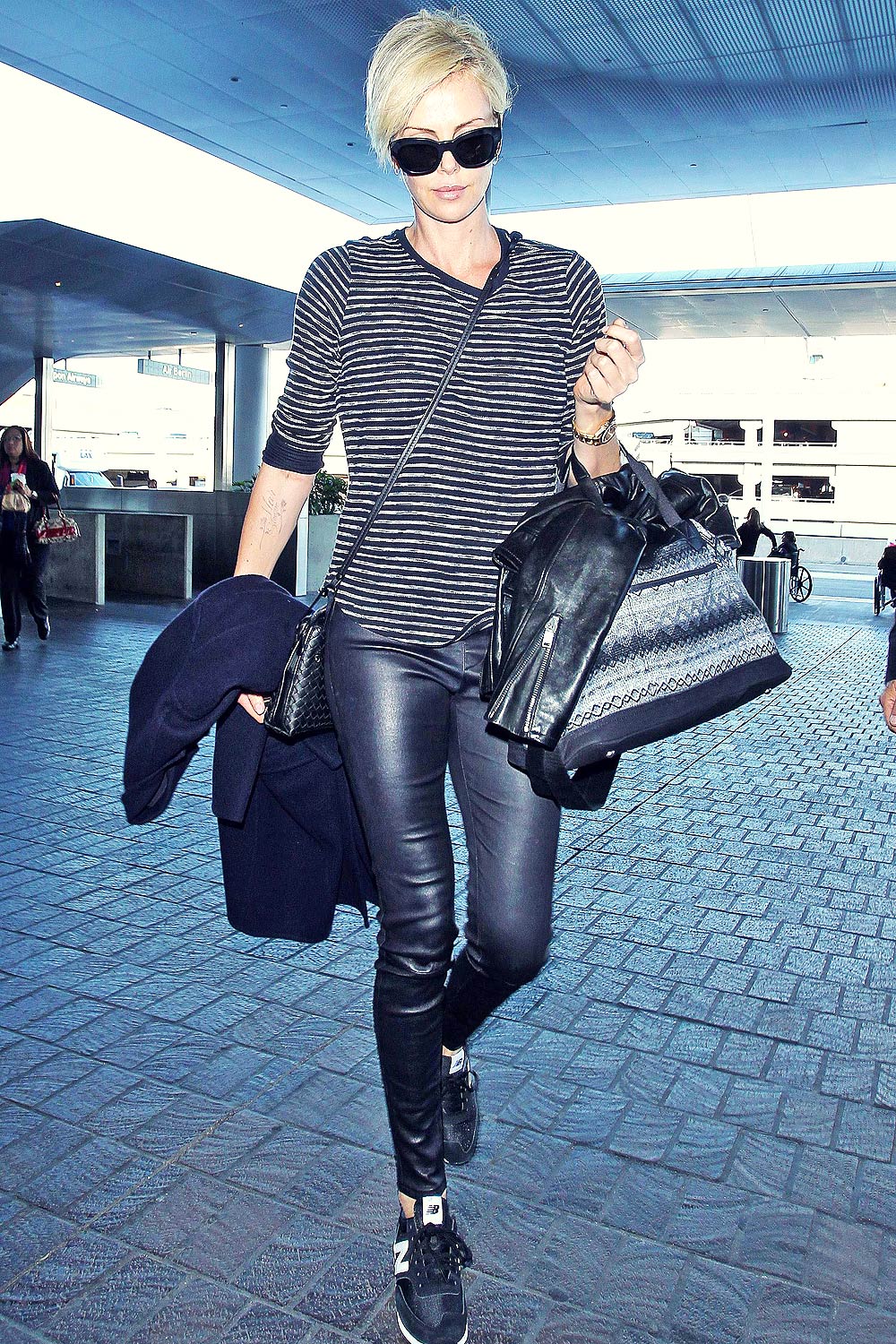 Charlize Theron arrives at LAX Airport - Leather Celebrities