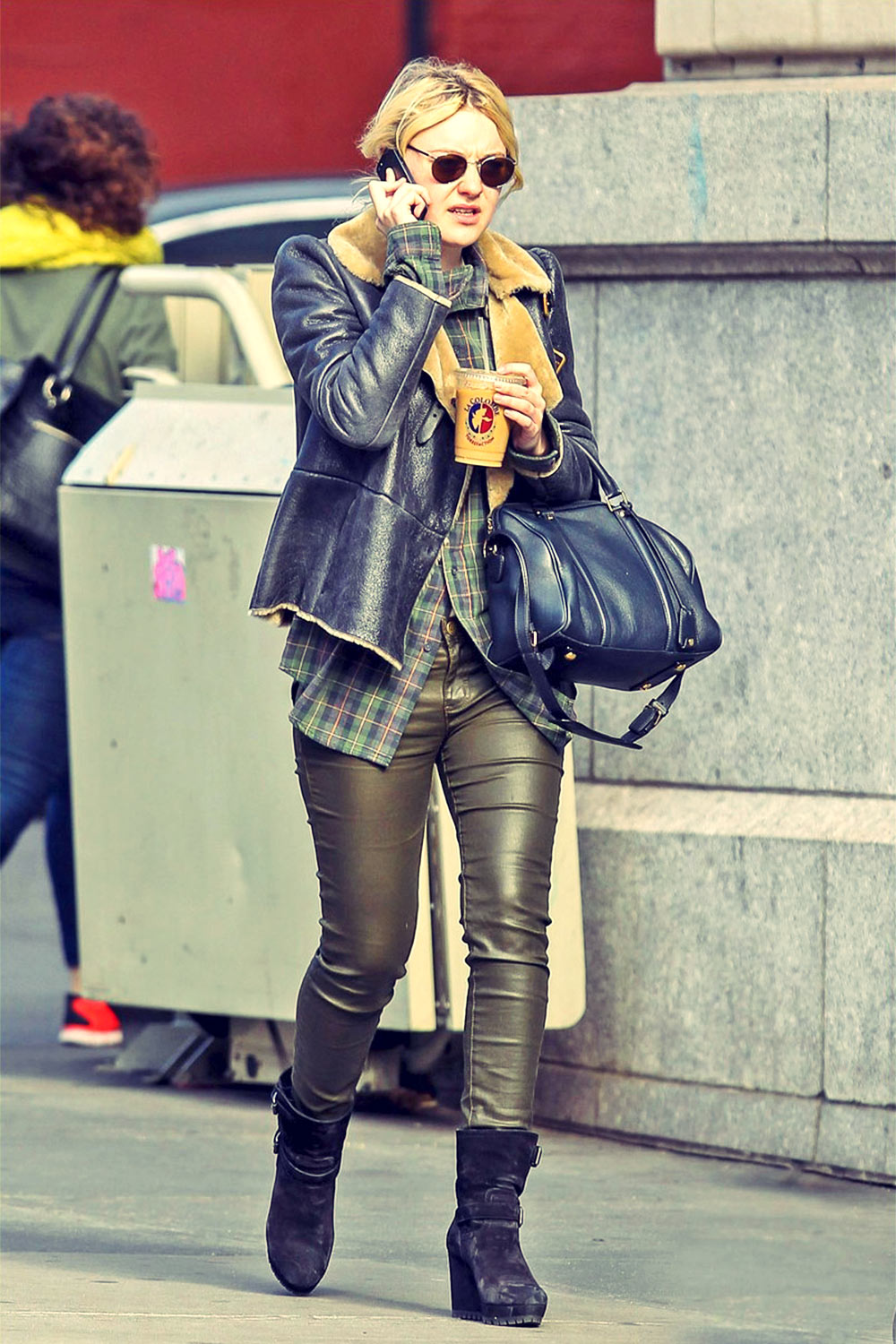 Dakota Fanning strolls through Soho with a cup of coffee