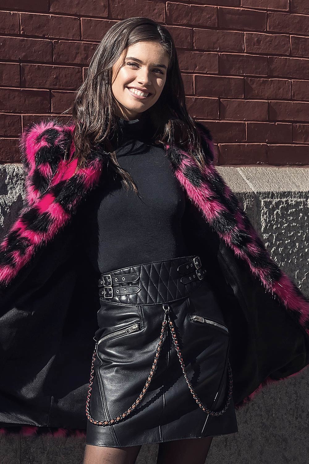 Sara Sampaio wearing a pink black leoprint coat outside Marc Jacobs